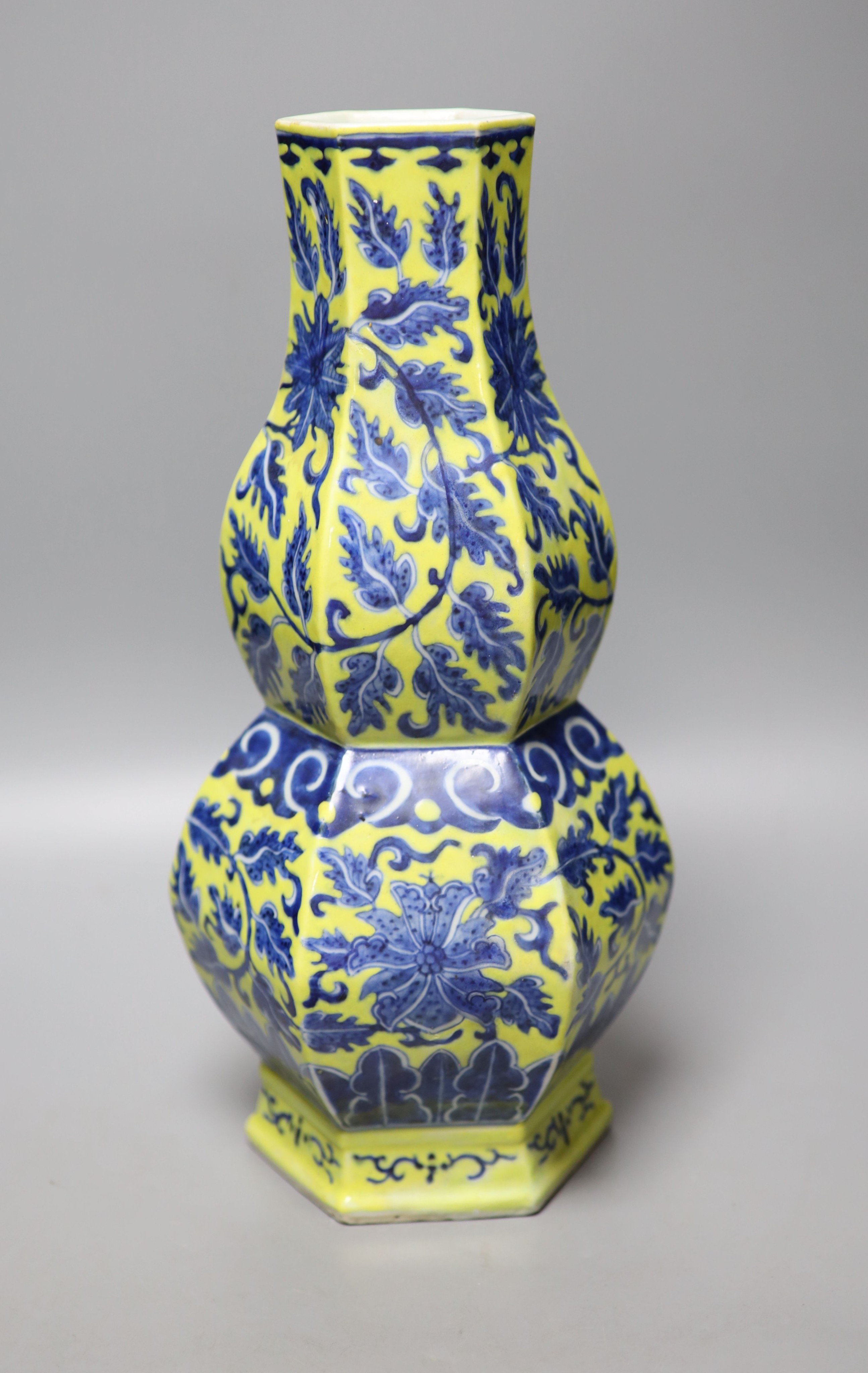 A Chinese underglaze blue yellow ground hexagonal vase, early 20th century, some restoration 35cm